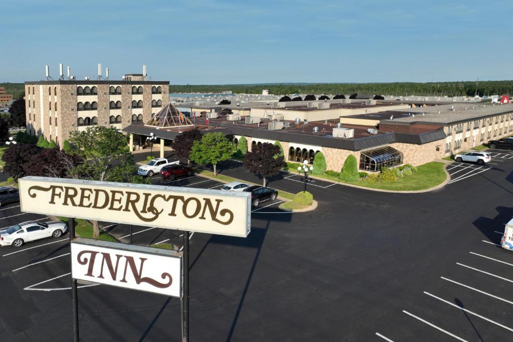 a parking lot with a sign in a parking lot at The Fredericton Inn in Fredericton