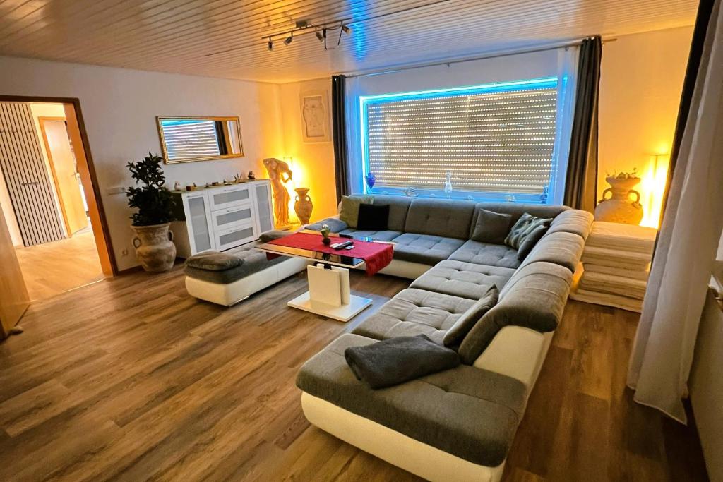 a living room with a couch and a table at Die Panorama-Wohnung-im-Grünem in Allensbach