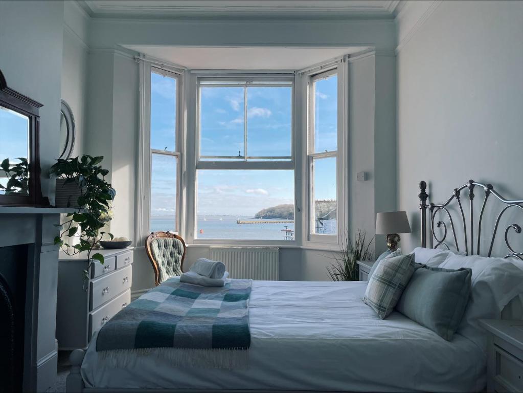 a bedroom with a bed and a large window at Beds at 46, Cowes in Cowes