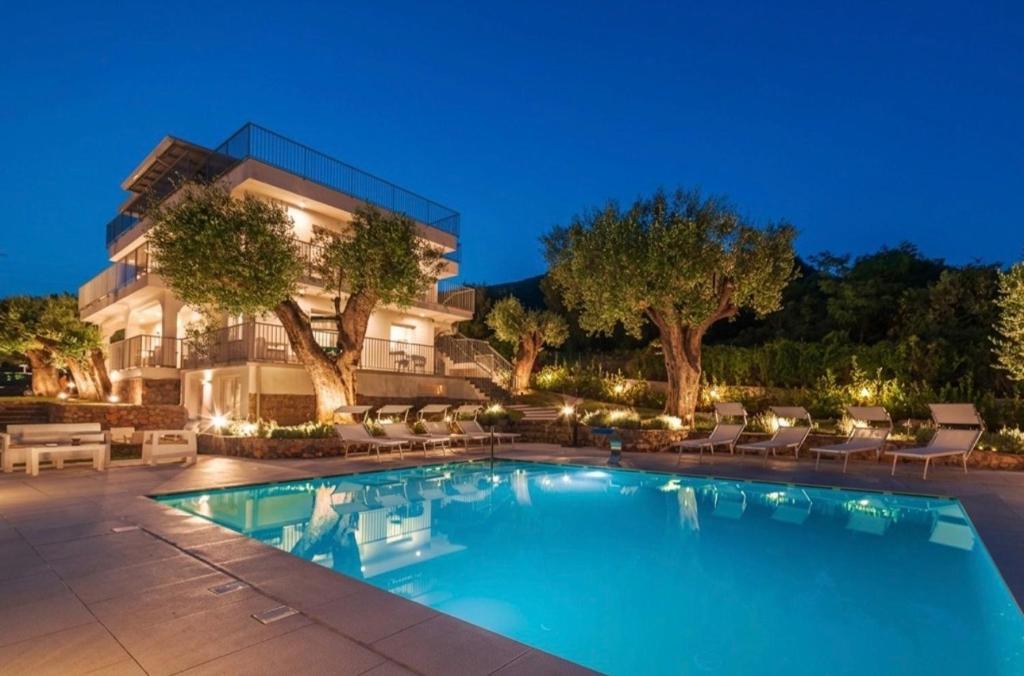a swimming pool in front of a house at Micabalù Luxury Apartment in Marina di Camerota
