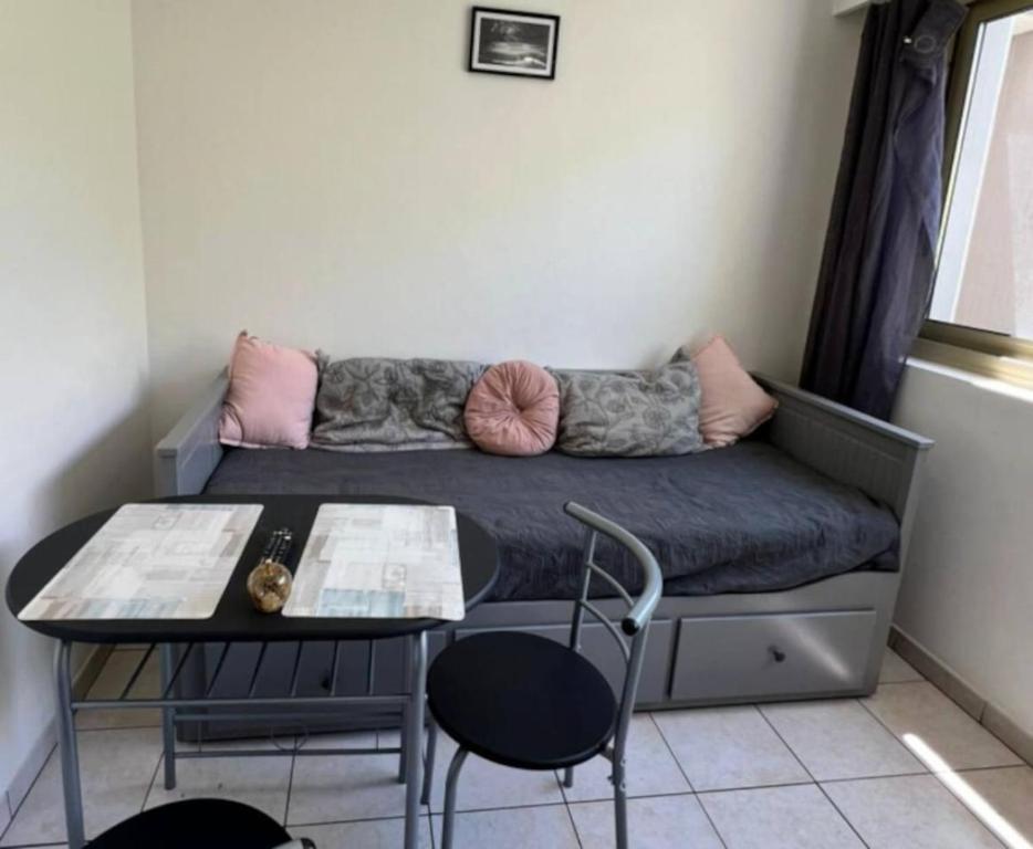 a small room with a couch and a table at Studette au centre des marina- smart in Villeneuve-Loubet
