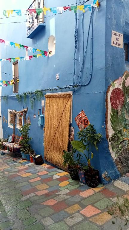 a blue building with a door and plants in front of it at LA CASA AZUL in Chelva
