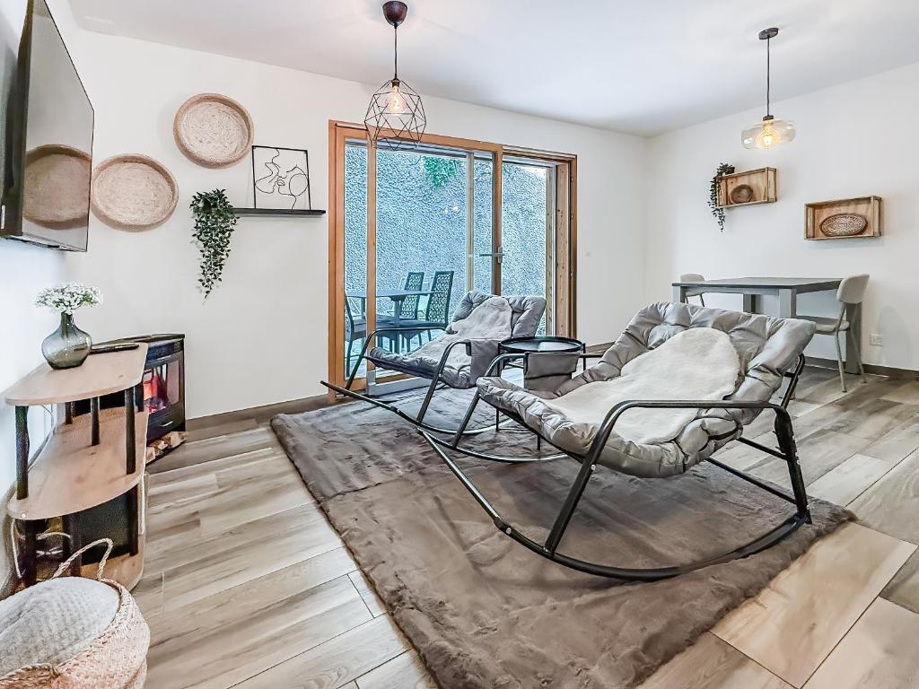a living room with two chairs and a table at Apartment Lotus in Ovronnaz
