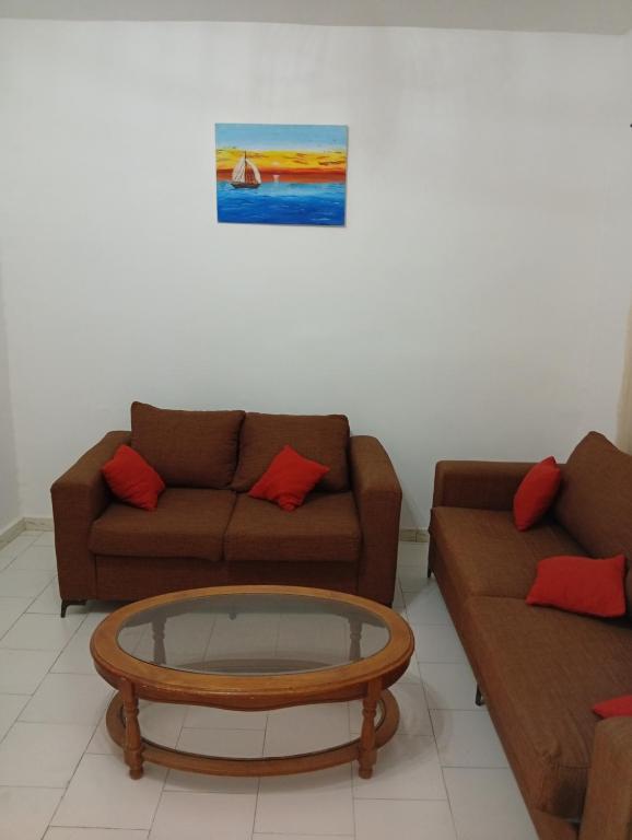 a living room with two couches and a coffee table at Chez Mounas in Saint-Louis