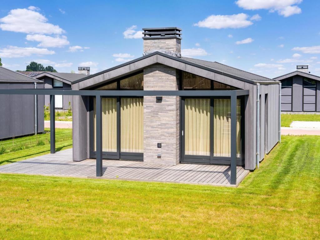 a house with a deck in the grass at Amsterdam in Oud-Ade