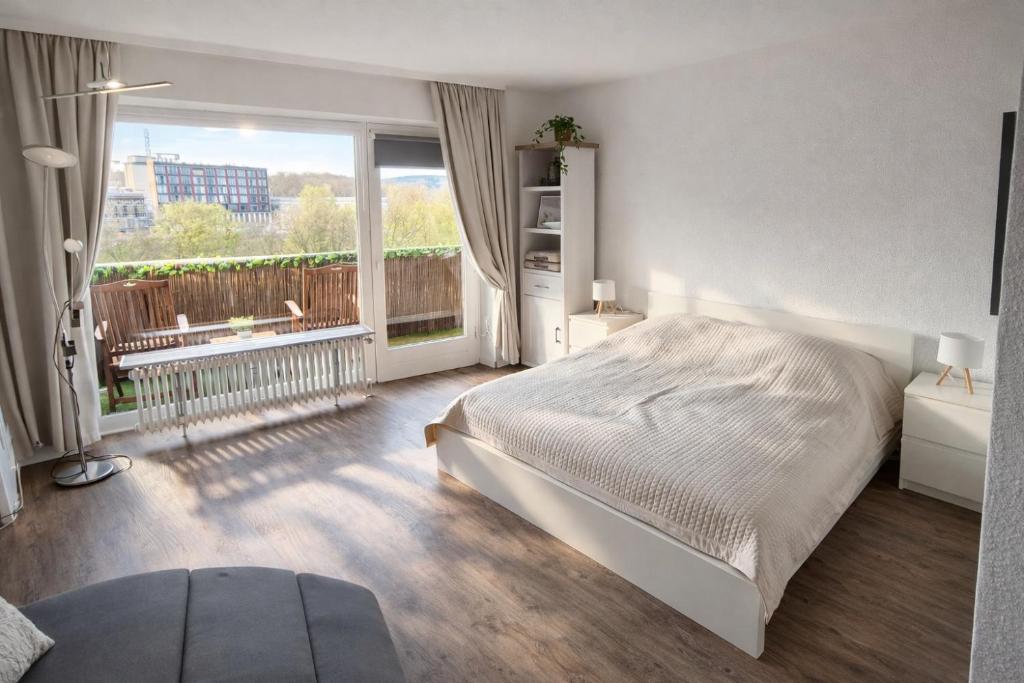 a bedroom with a bed and a large window at Gemütliche Auszeit in Bad Rothenfelde in Bad Rothenfelde