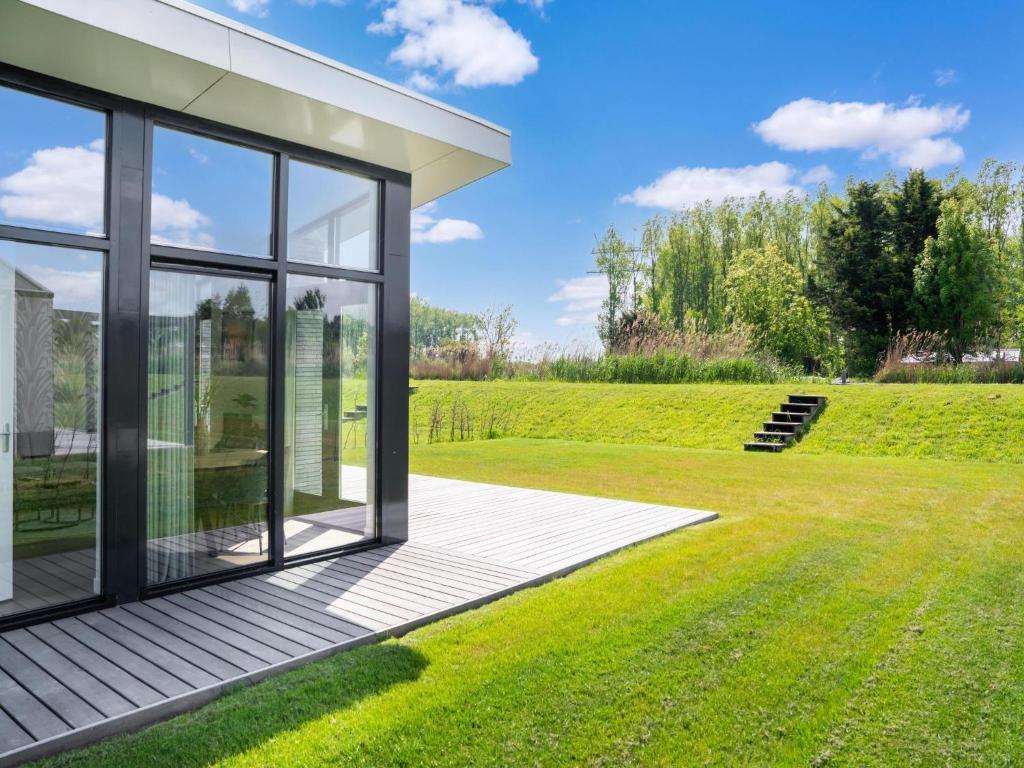a glass house with a garden at Polder in Oud-Ade