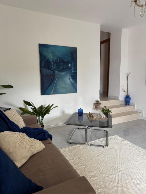 a living room with a couch and a table at La Scaletta - Charming Historic Center Home - Mountain View in San Nicola Arcella
