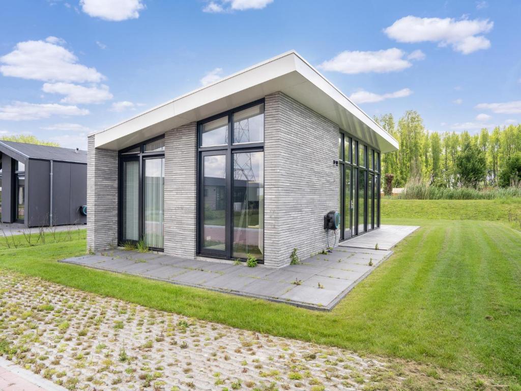 a house with a large window on a lawn at Kaag in Oud-Ade