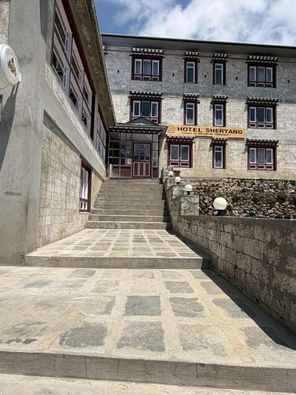 a building with a staircase leading up to a door at Hotel Sheryang in Namche
