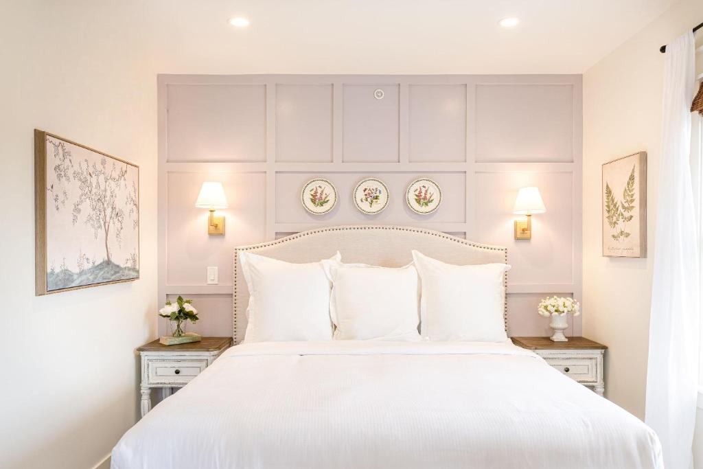 a bedroom with a large white bed with white pillows at Kildahl House - Boutique Farmhouse Suite #3 in West Dundee