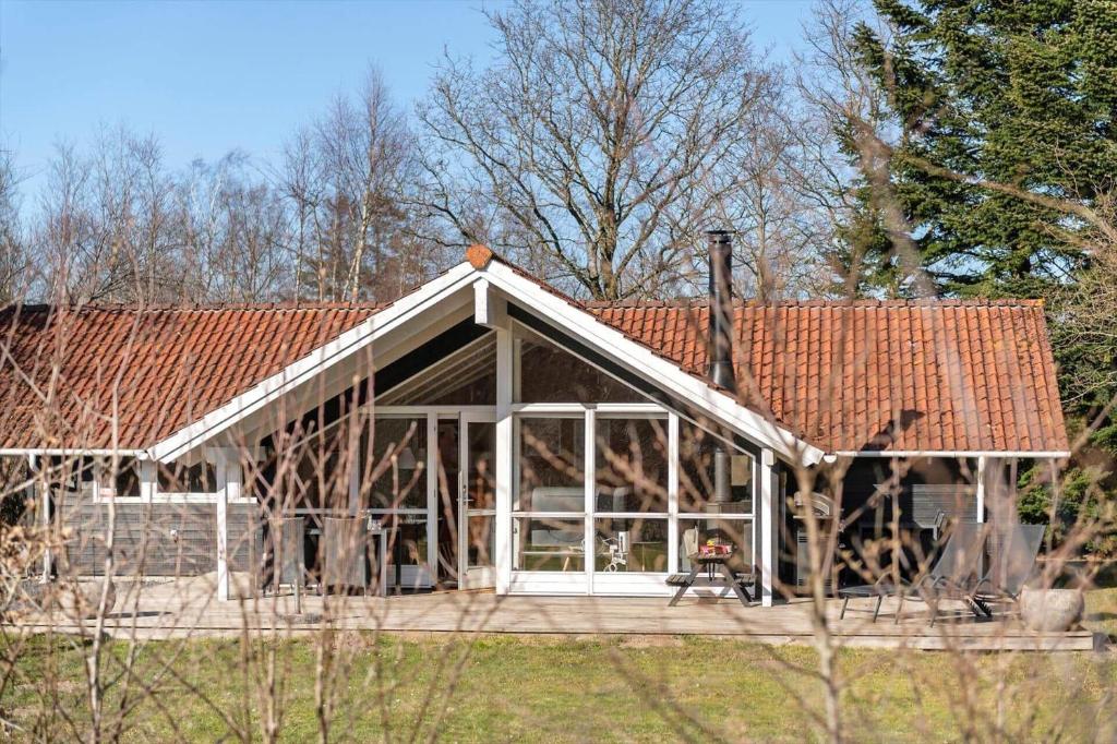 a house with a conservatory with a red roof at VE508-Oksbol-Blomstervangen-123 in Oksbøl