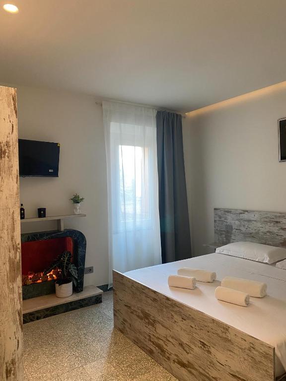 a bedroom with a large bed and a fireplace at BORGO MARE 86 rooms in Porto SantʼElpidio