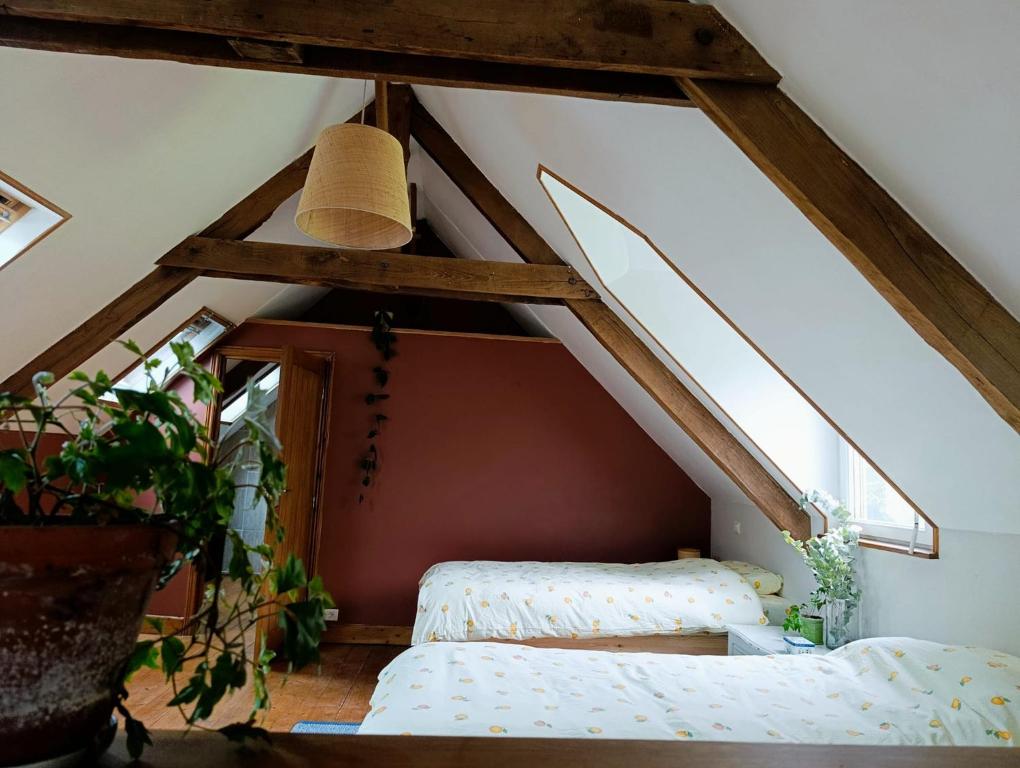 a room with two beds in a attic at Les champs sauvages in Saint-Barnabé