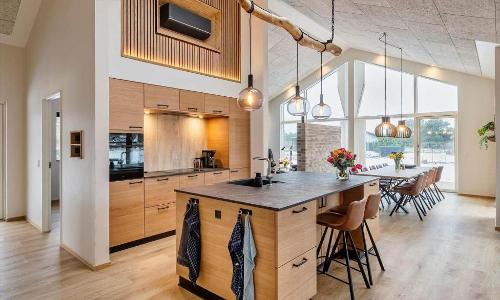 a kitchen with a large island and a dining table at VE250-Vejers-Strand-Engesovej-56 in Vejers Strand
