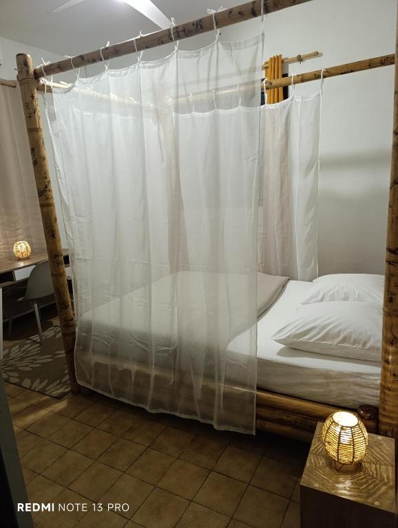 a bed with a canopy in a room at NM-Housing in Saint-Denis