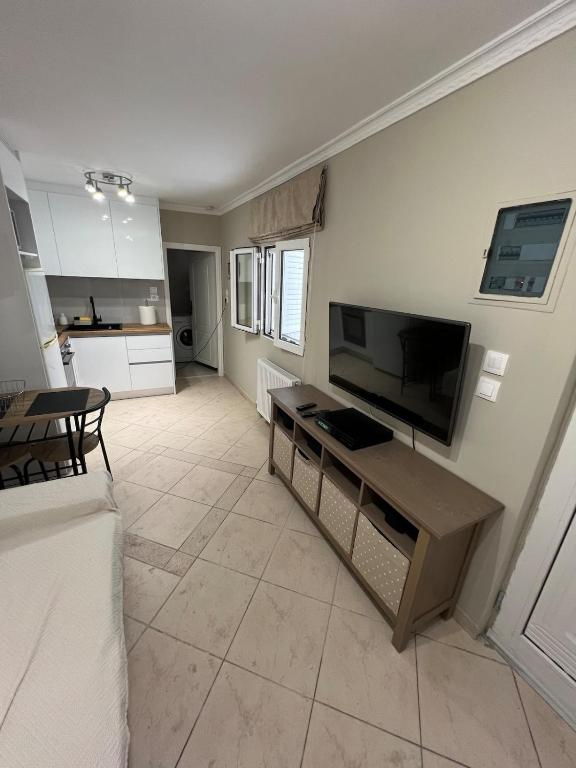 a living room with a large flat screen tv at Nice apartment close to the sea in Athens