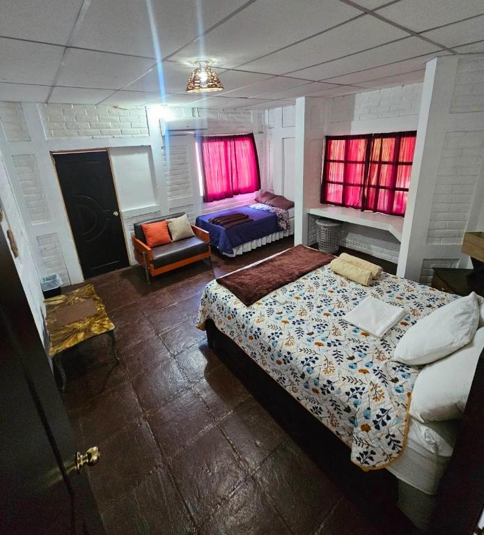 a bedroom with a bed and a couch in it at Jaco Mizata Beach and River in La Libertad