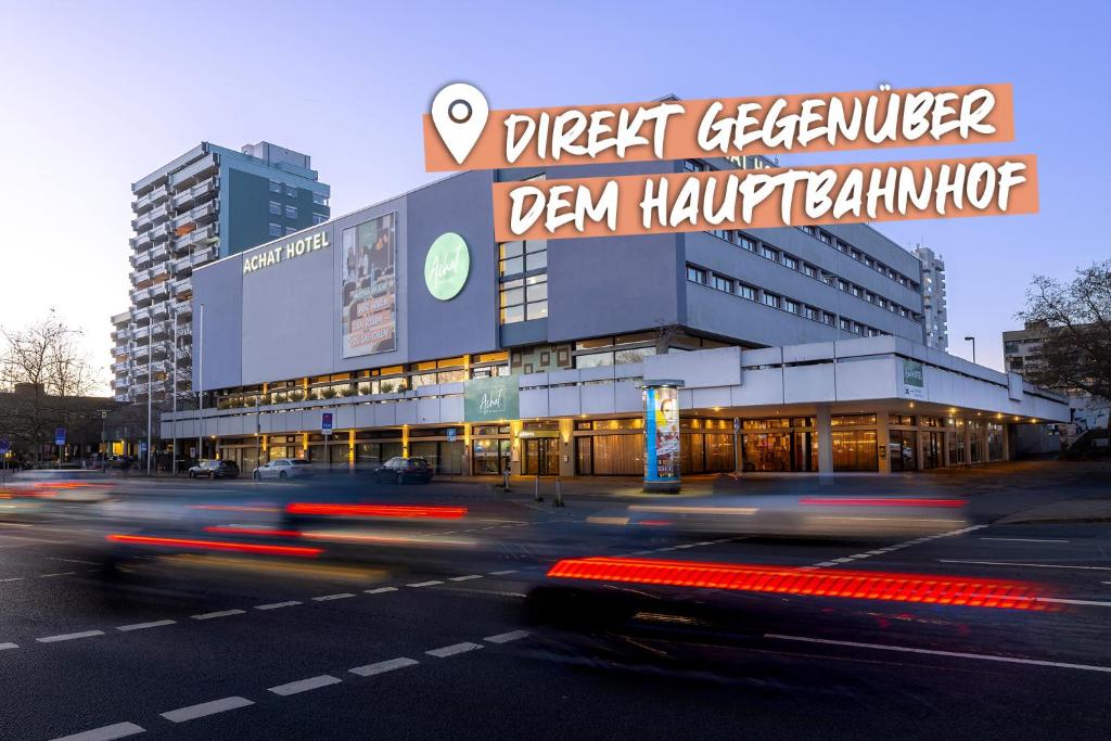 a building with a sign on it on a city street at ACHAT Hotel Braunschweig in Braunschweig