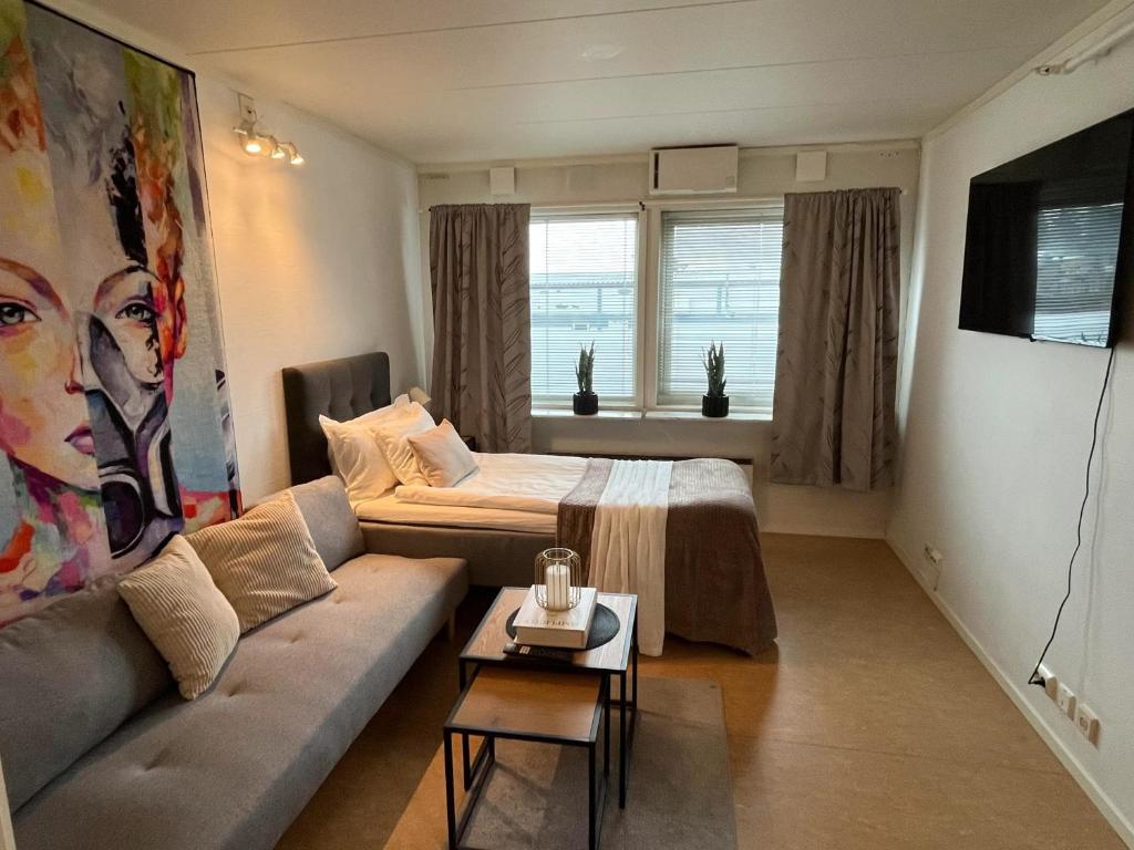 a living room with a couch and a bed at North Home in Skellefteå