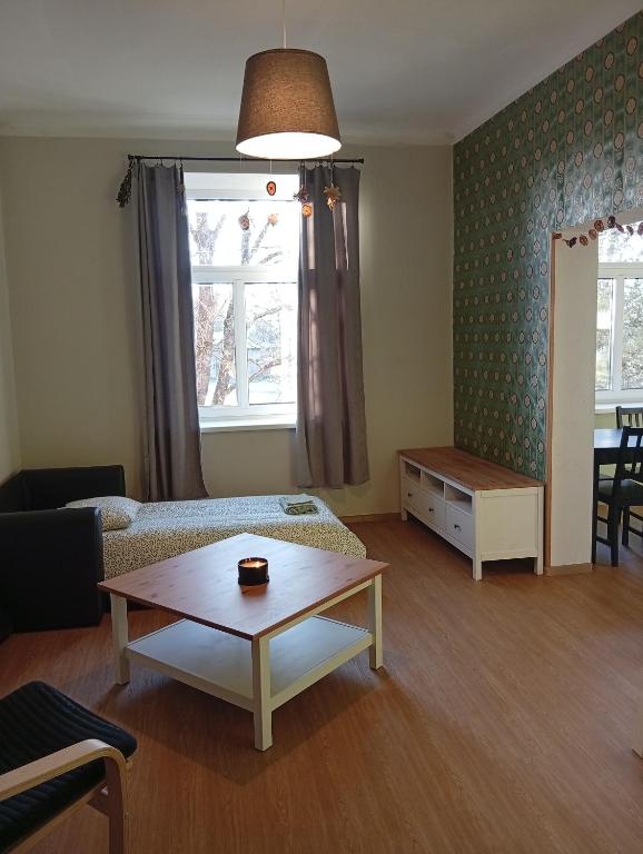 a living room with a couch and a coffee table at Lendle Apartment Märjamaa in Märjamaa