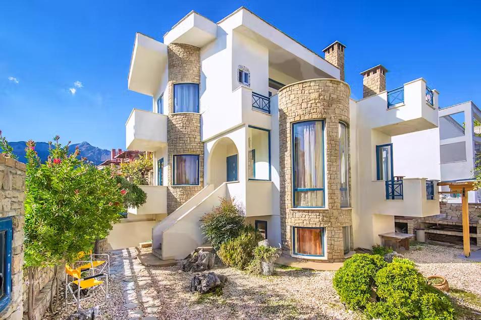 a large white building with a yard in front of it at Villa Markella in Chrysi Ammoudia