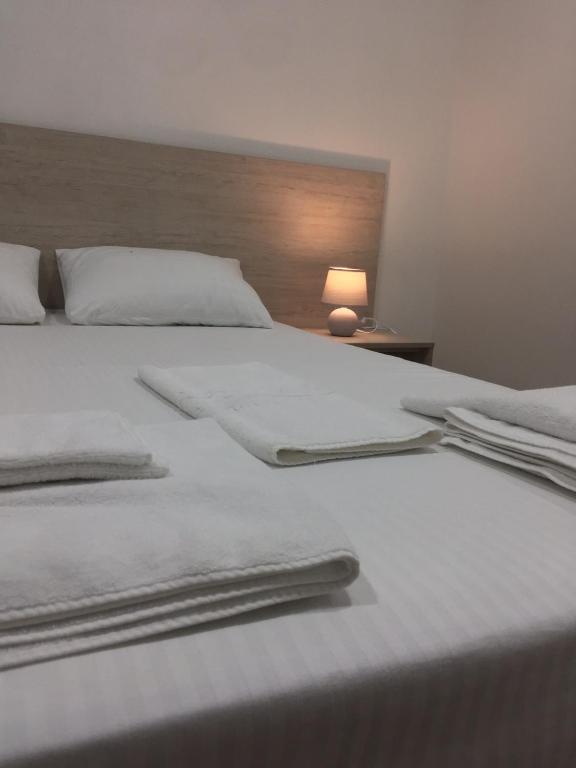 a large white bed with white sheets and pillows at Hotel BK in Kyiv