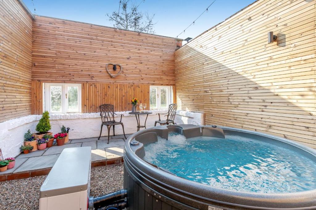 a large hot tub in a patio with a table and chairs at 2 Bed in Southwell oc-n30605 in Southwell