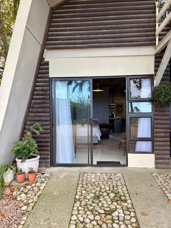 a house with sliding glass doors leading to a bedroom at Esperanza Dira's in George