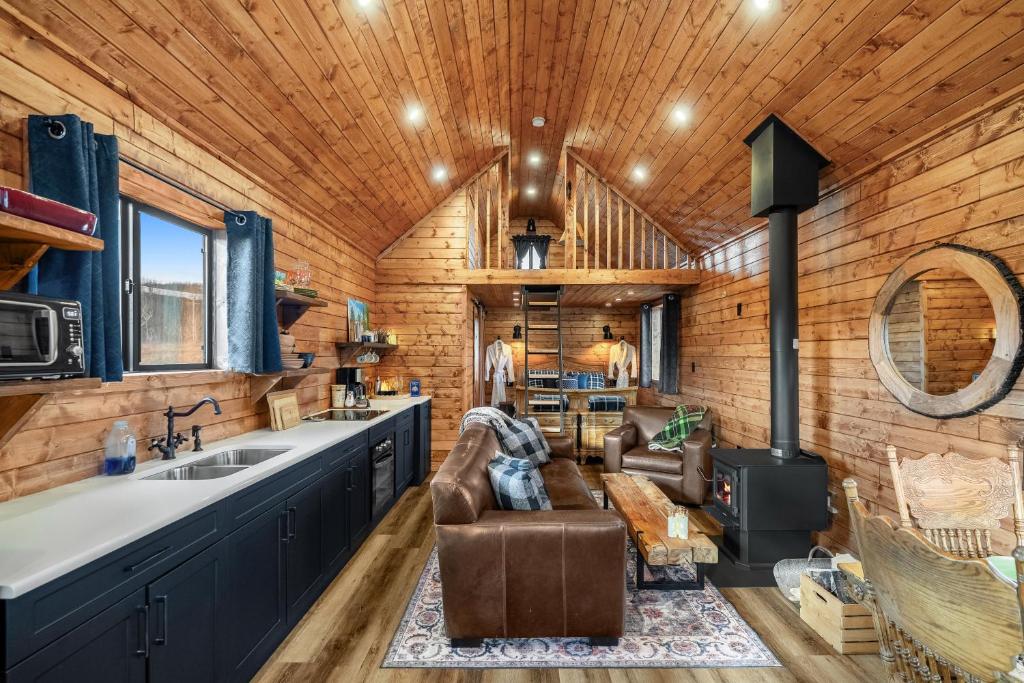 a living room with a couch and a stove at River Retreat Kananaskis in Turner Valley