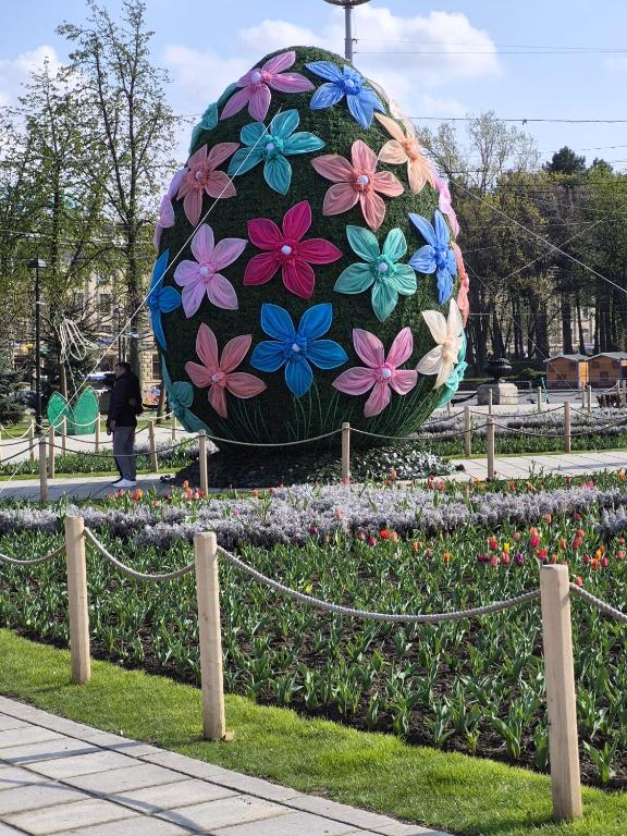 a large flower ball in the middle of a park at Cathedral Park Smart Apartment in Chişinău