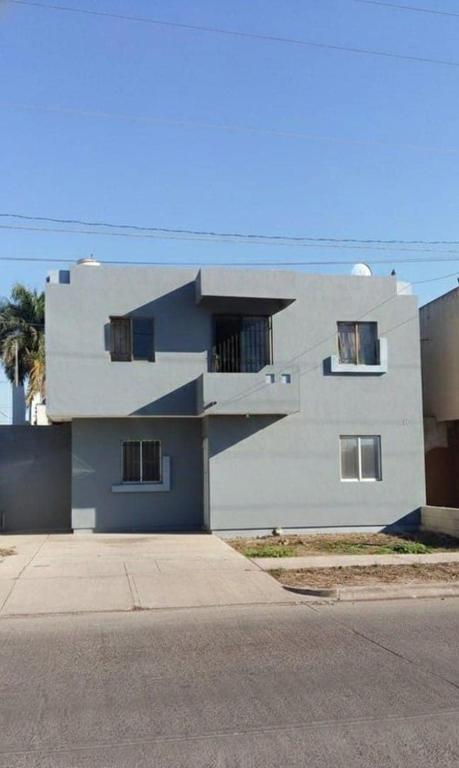 a large white building with windows on the side of it at Tu hogar ideal, cómodo, acogedor y único in Los Mochis