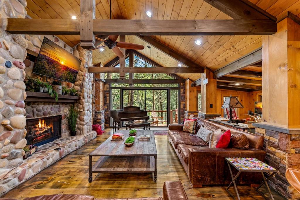 a living room with a couch and a fireplace at Big Bear Falls in Ellijay