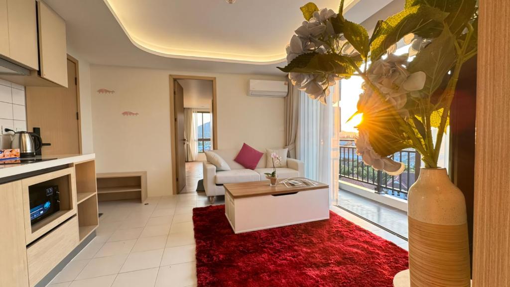 a living room with a couch and a table at 2BR Fantasea condo kamala in Kamala Beach