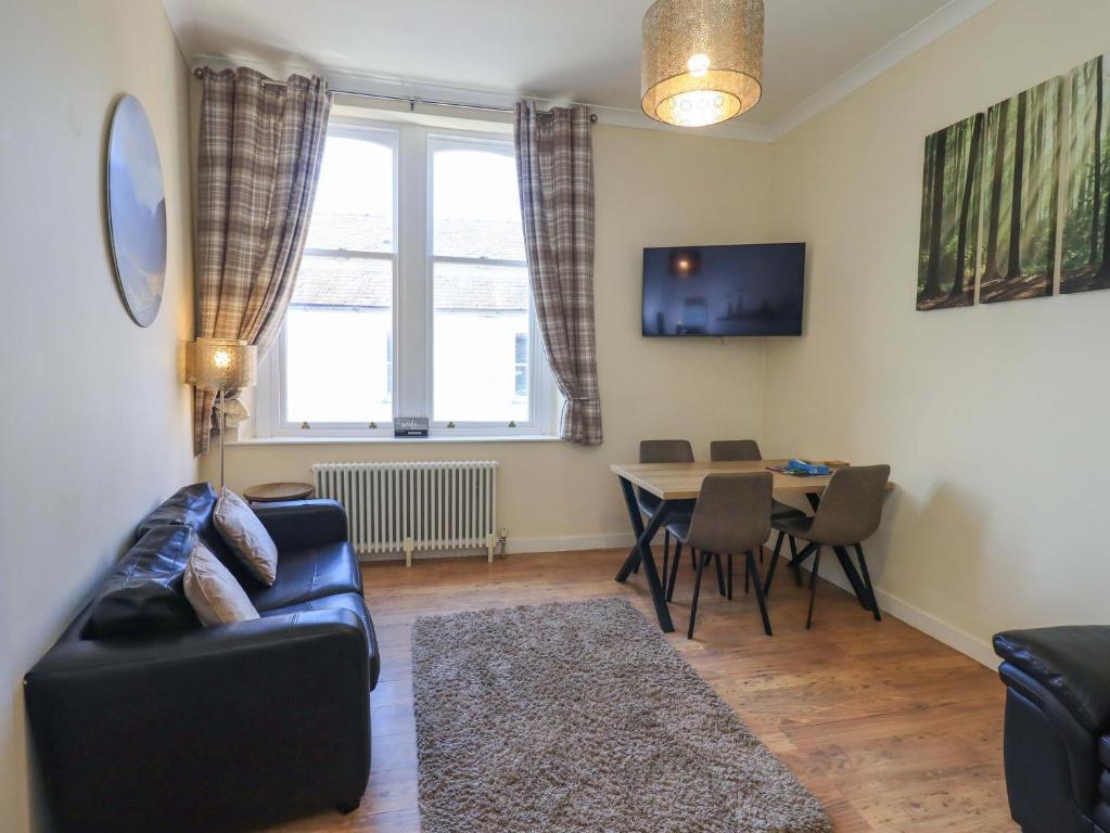 a living room with a couch and a table at St Johns View in Keswick