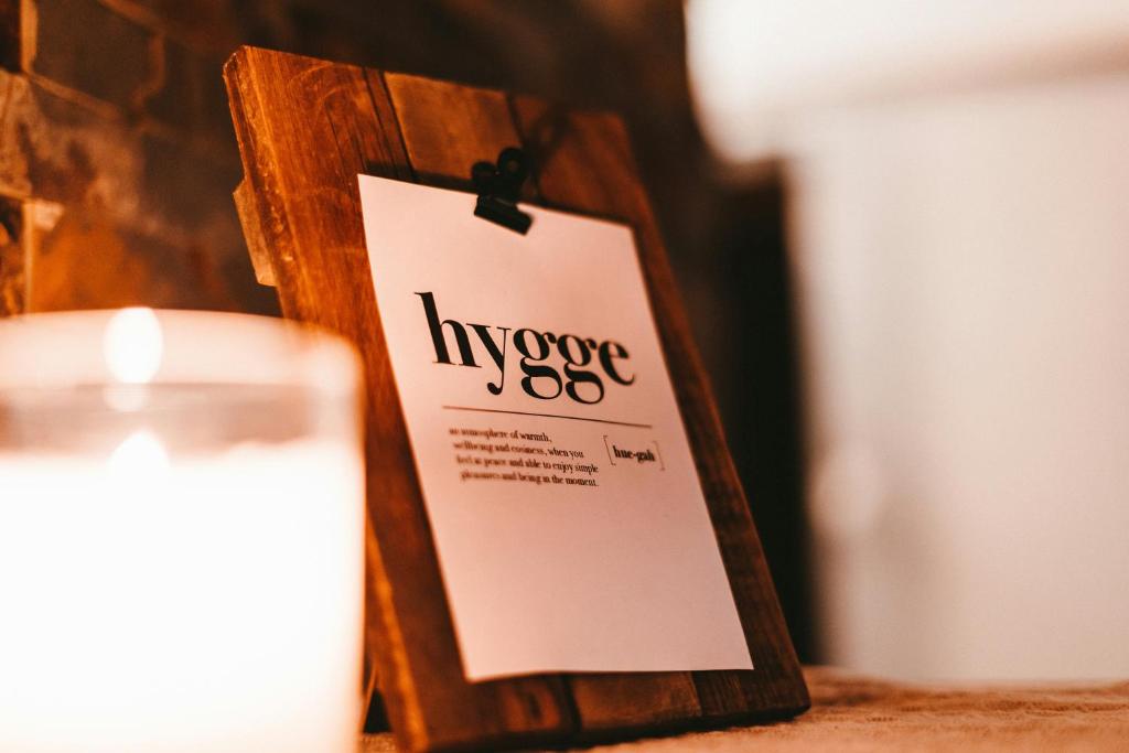 a sign sitting next to a candle next to a candle at Hygge Somerset in Street