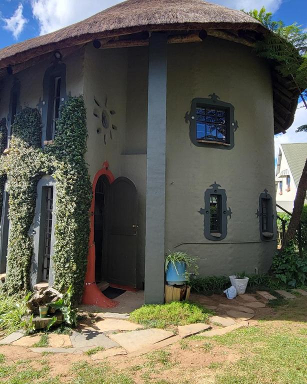 a small house with a thatched roof at The Storybook Nook in Kaapsehoop
