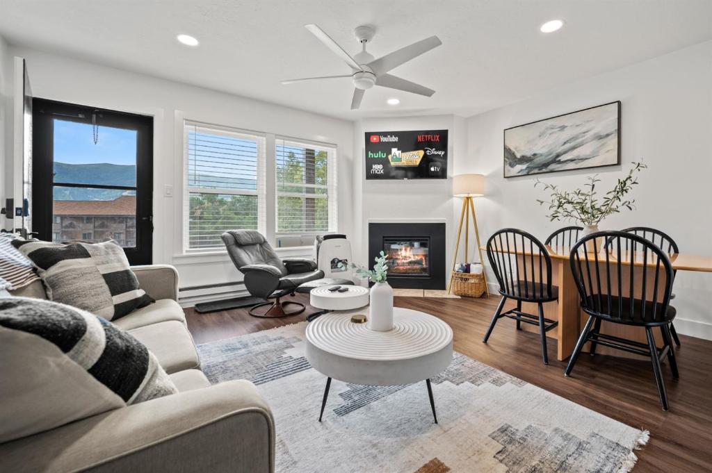 a living room with a couch and a table and chairs at Welcoming Wolf Getaway WL1405 Ski Escape Hot Tub in Eden
