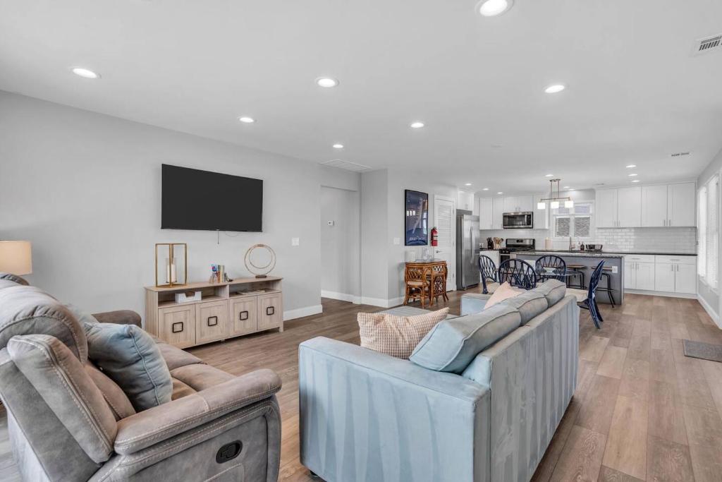 a living room with two couches and a kitchen at Prof Cleaned | Fast WiFi | BBQ | Linen & Towels in Seaside Heights