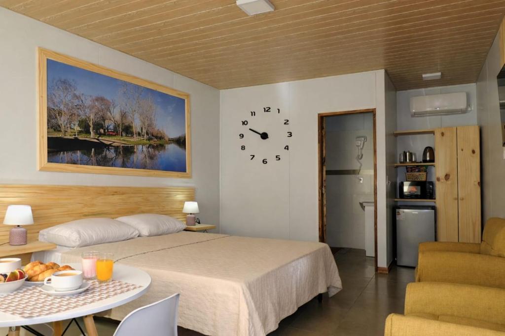 a bedroom with a bed and a clock on the wall at Jardines Inn in Trinidad