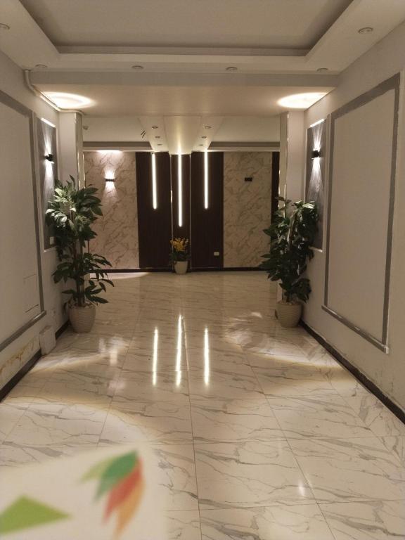 a hallway with potted plants in a building at Sone Al Boos in Cairo