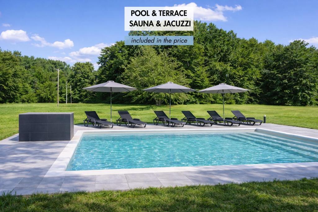 a swimming pool with lounge chairs and umbrellas at Apartmaji Živa in Gornja Radgona