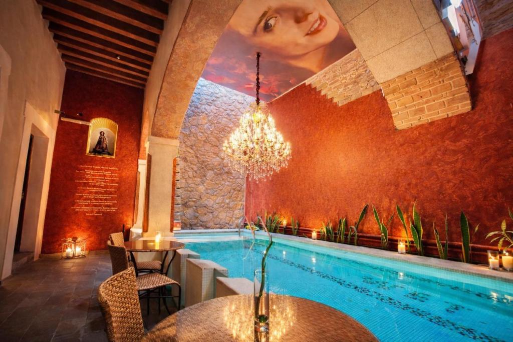 a swimming pool in a restaurant with a painting on the wall at El Sueño Hotel & Spa in Puebla