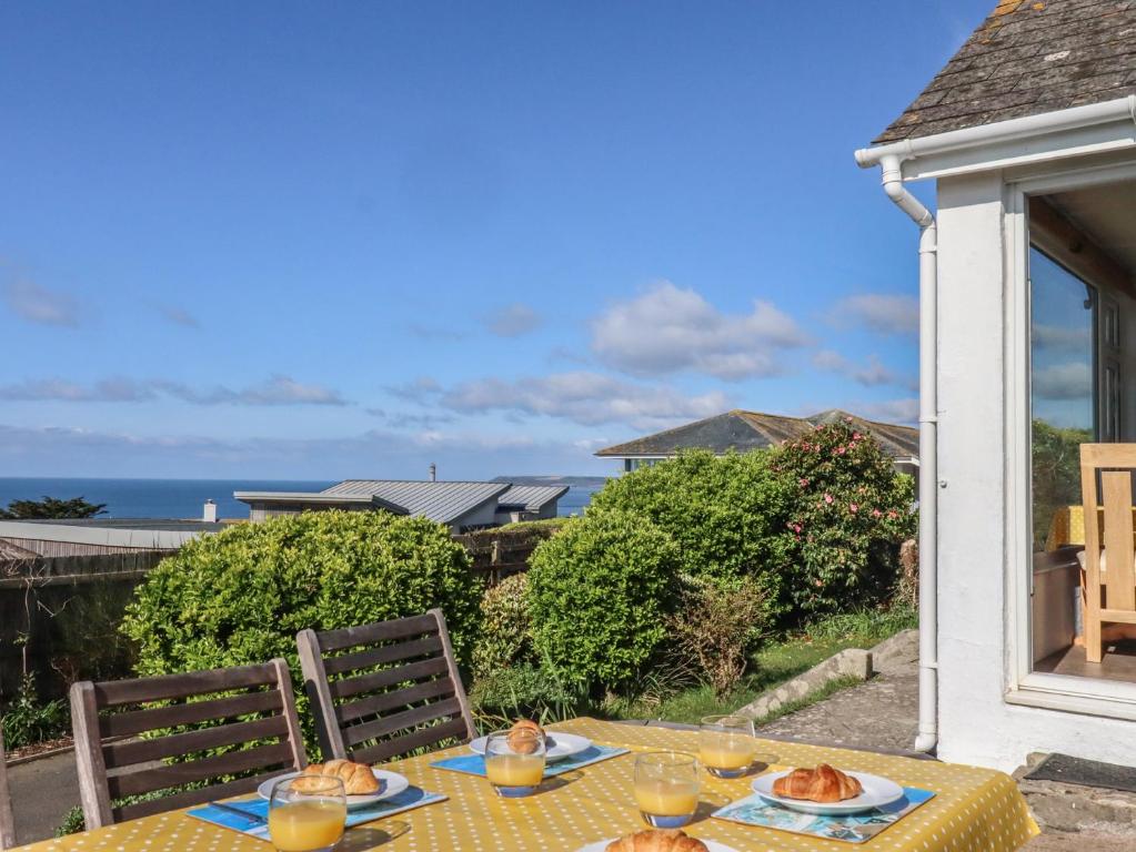 a table with plates of food on top of a house at Highdown in Bigbury on Sea