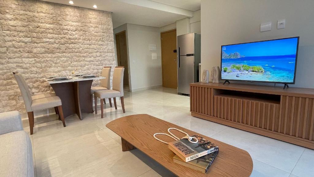 a living room with a large flat screen tv at Urban Stay Botanic in Goiânia