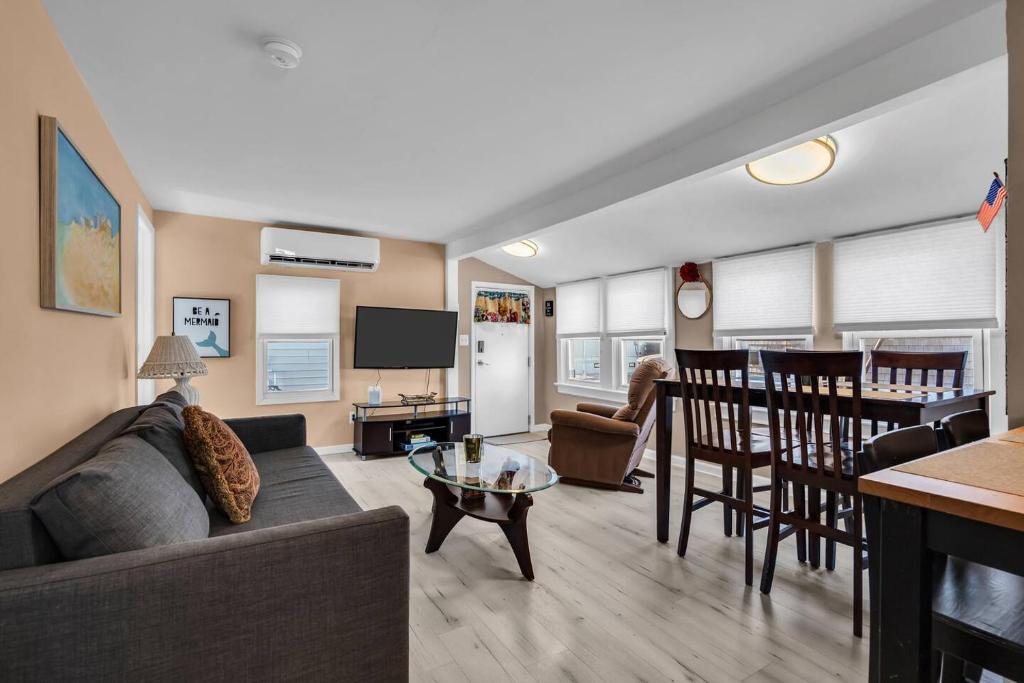 a living room with a couch and a table at Fast Wi-Fi | Linen & Towel | Coffee | Prof Cleaned in Seaside Park
