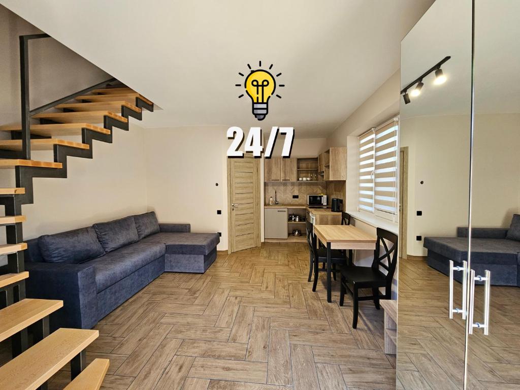 a living room with a couch and a table with a light bulb at Villa Karta in Berehove