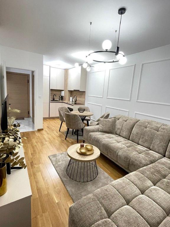 a living room with a couch and a table at Tiffany Delux in Banja Luka