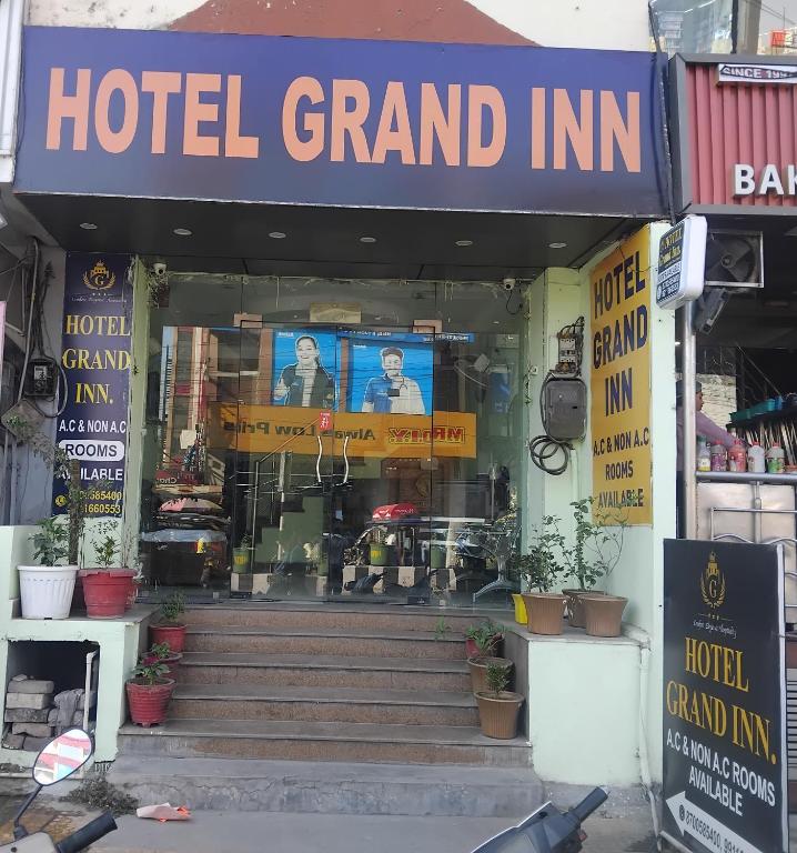 a hotel grand inn with stairs in front of it at Hotel Grand Inn in Haridwār