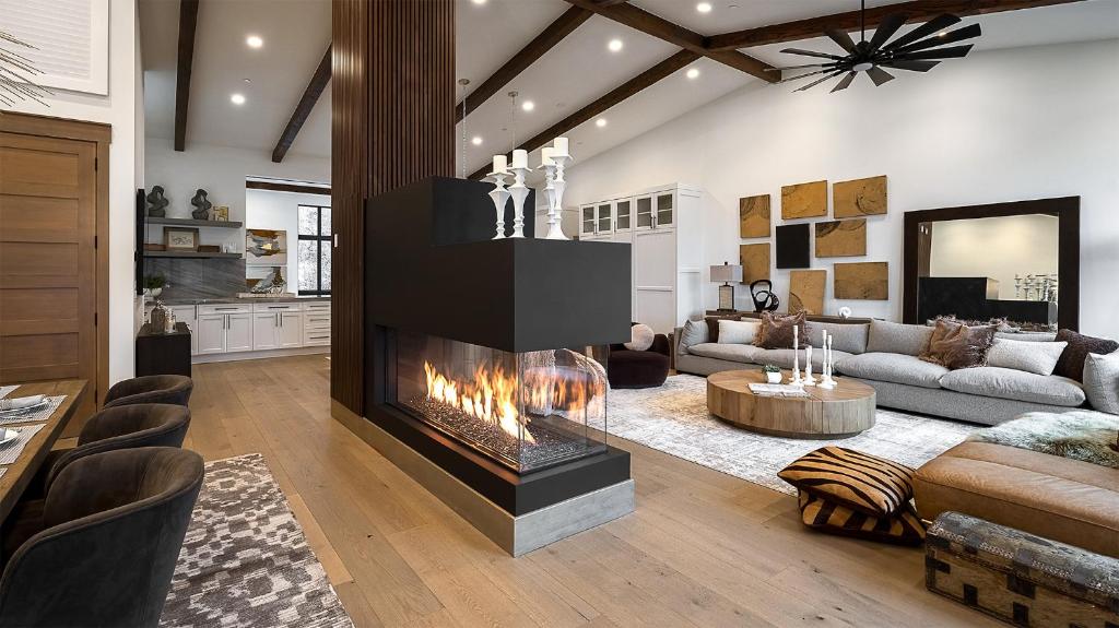 a living room with a fireplace in the middle at Allegro Peak in Steamboat Springs